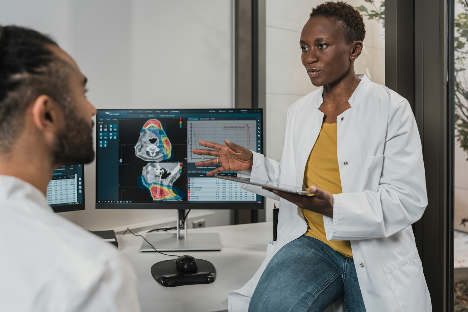 Two scientists reviewing molecular data on screen
